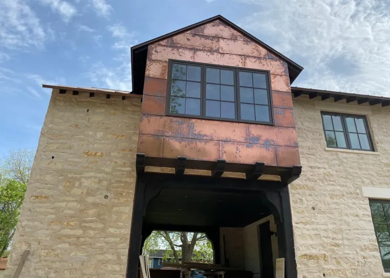 Copper metal panel facade on a stone building for Skylight Installation in Talladega